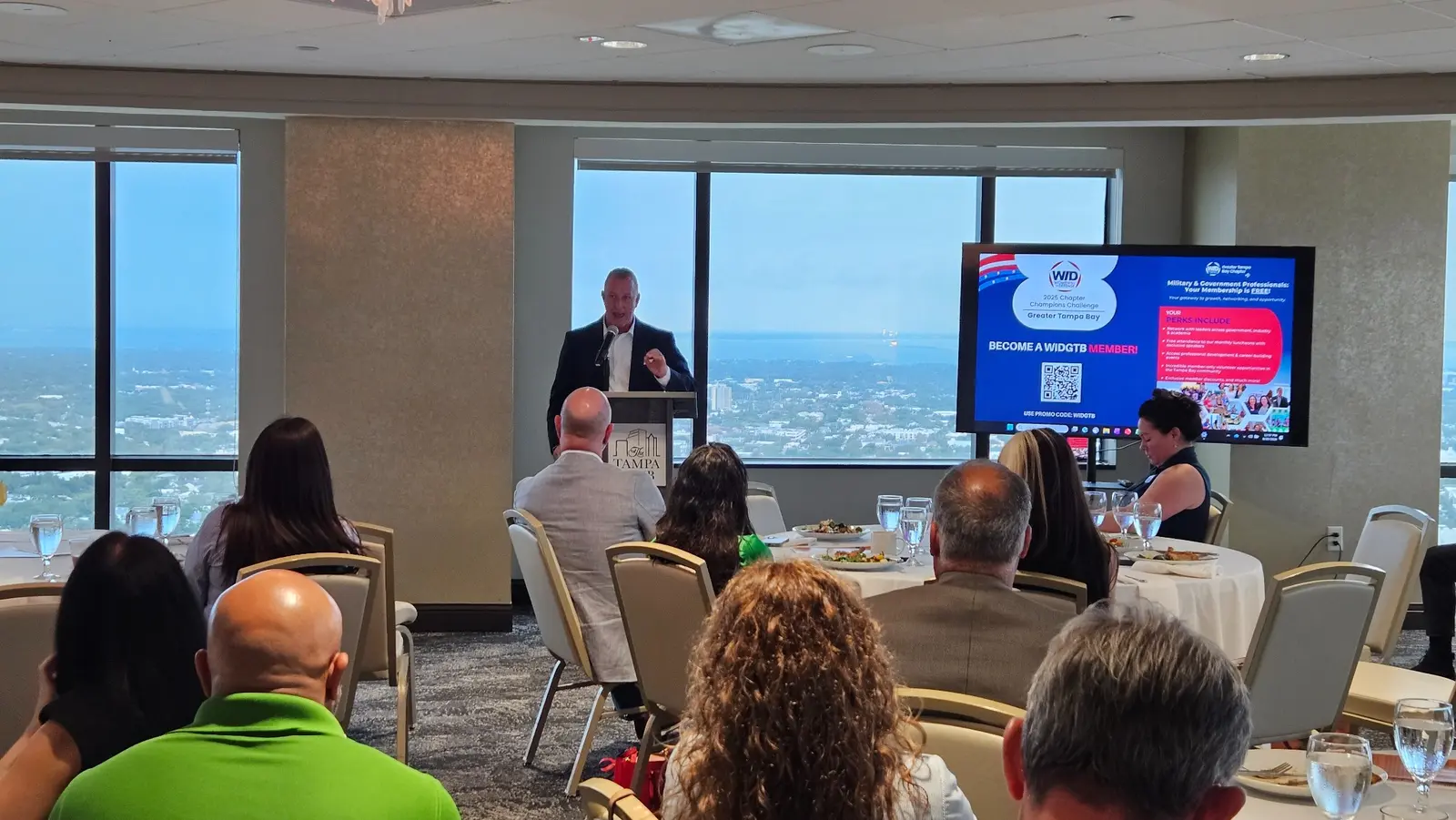 Blake Glass delivering a keynote to Women In Defense Greater Tampa Bay at The Tampa Club on August 20, 2026